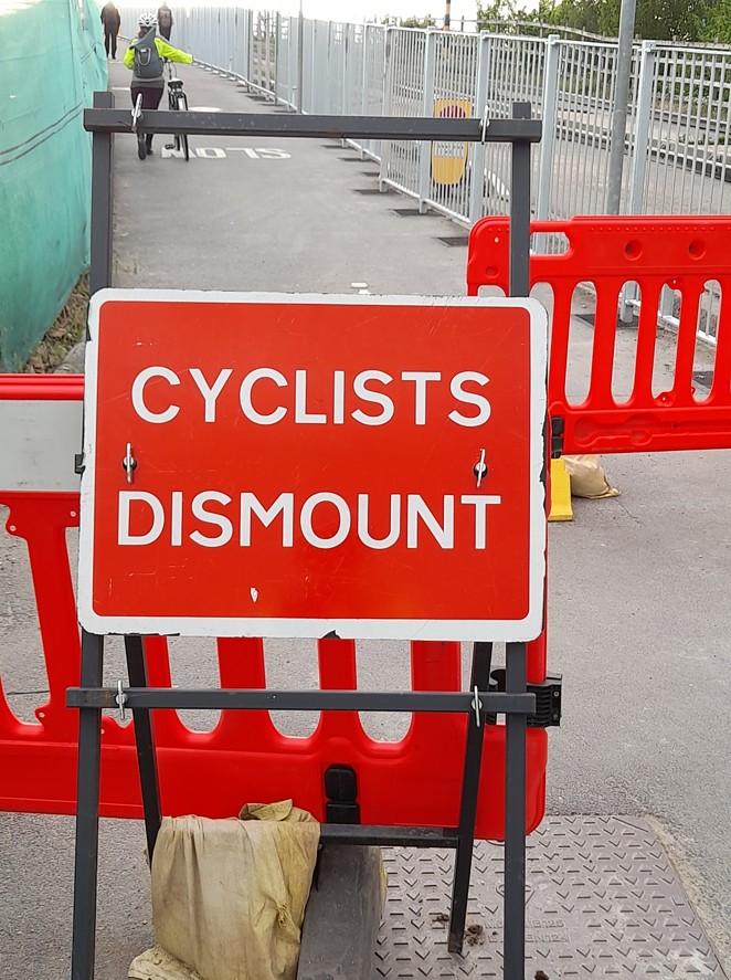 Cambridge Biomedical Campus Busway Bridge Cyclists Dismount sign